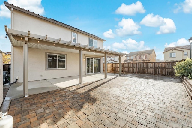 back of property with a patio, fence, a pergola, and stucco siding