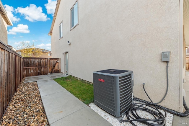 view of yard featuring central AC unit and fence