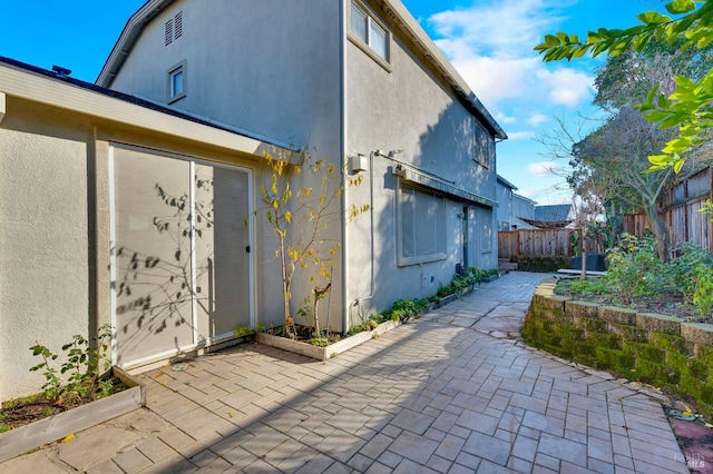 view of side of home featuring a patio