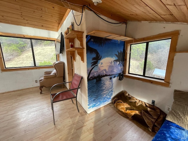 living area with light hardwood / wood-style flooring, vaulted ceiling, and wood ceiling