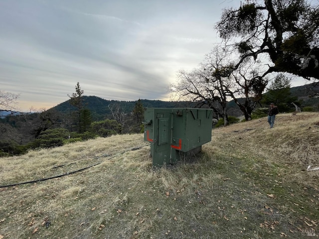 view of outdoor structure featuring a mountain view and a rural view