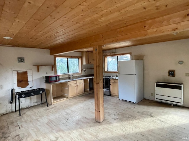 kitchen featuring light brown cabinets, gas range, white fridge, wood ceiling, and heating unit