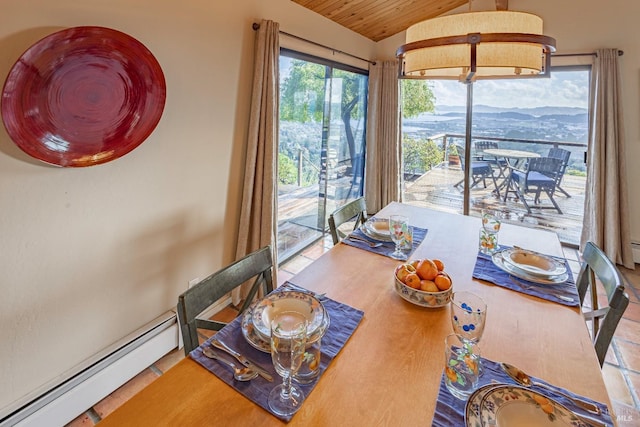 dining area featuring wood ceiling, vaulted ceiling, baseboard heating, a mountain view, and tile patterned flooring