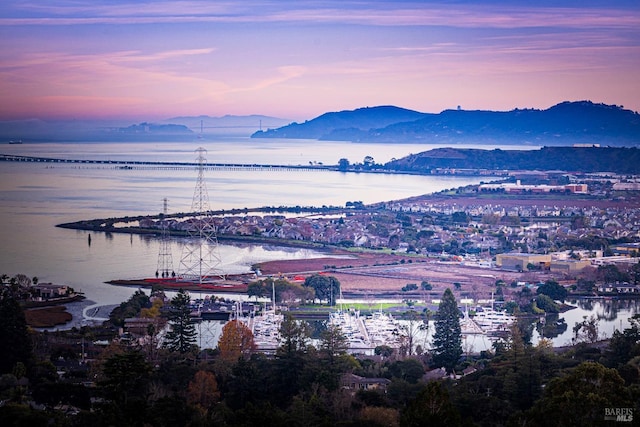 aerial view at dusk with a water and mountain view