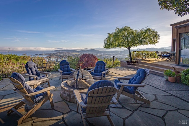 view of patio / terrace featuring a mountain view and an outdoor fire pit