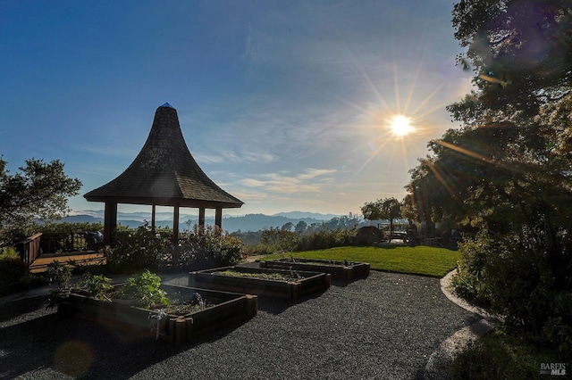 yard at dusk with a mountain view and a gazebo