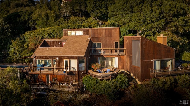 rear view of property featuring a balcony