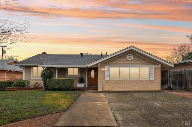 ranch-style house featuring a lawn