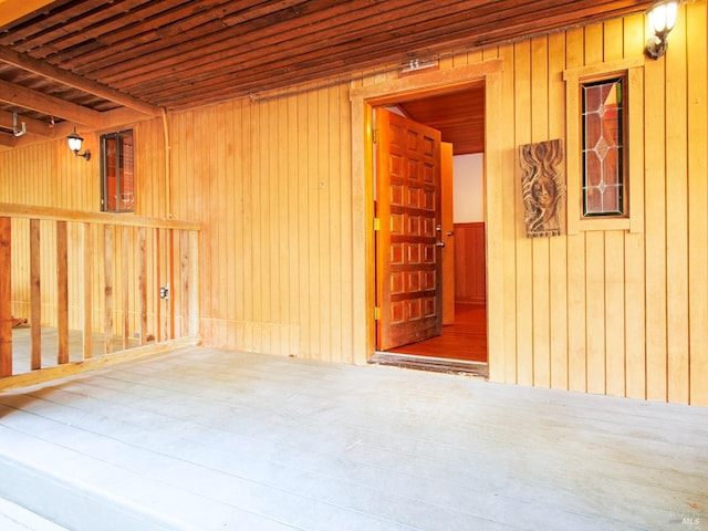 spare room featuring wood walls, hardwood / wood-style floors, and wooden ceiling