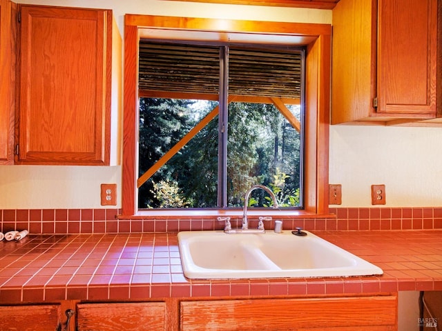 kitchen featuring tile countertops and sink