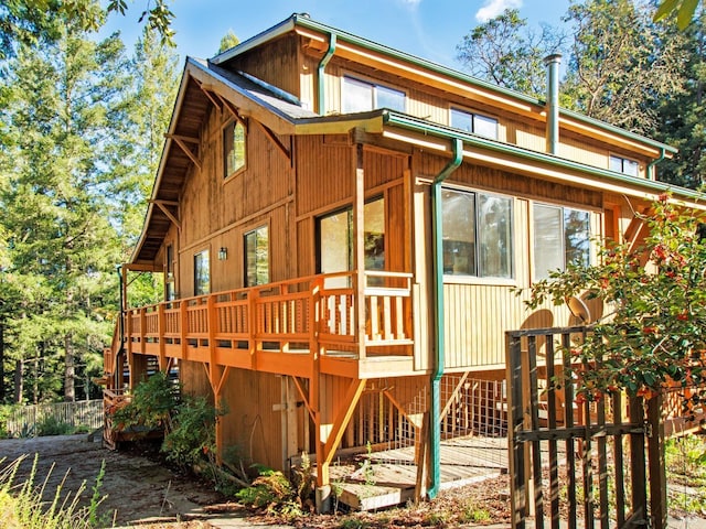 view of side of home with a deck