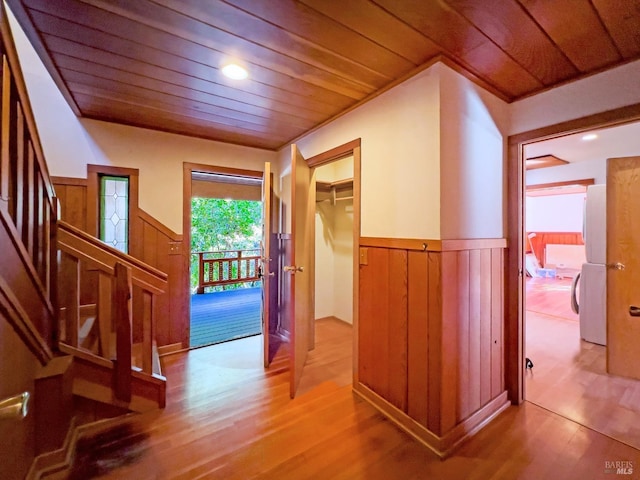 hall with wood ceiling and light wood-type flooring