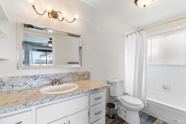 full bathroom with vanity, ceiling fan, shower / bath combo with shower curtain, wood-type flooring, and toilet