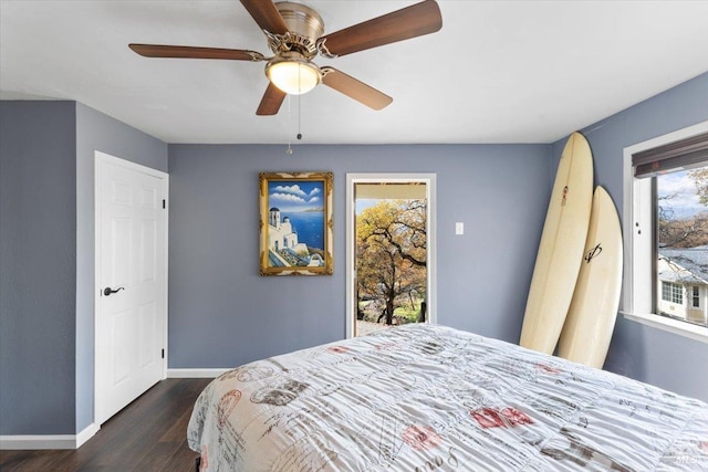 bedroom with ceiling fan, dark wood-type flooring, and access to outside