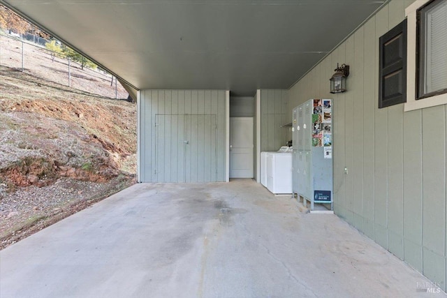 exterior space featuring washing machine and clothes dryer and a carport