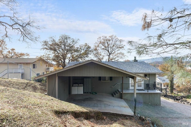 rear view of house with a carport and washing machine and dryer