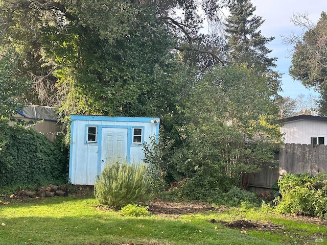 view of outbuilding featuring a lawn