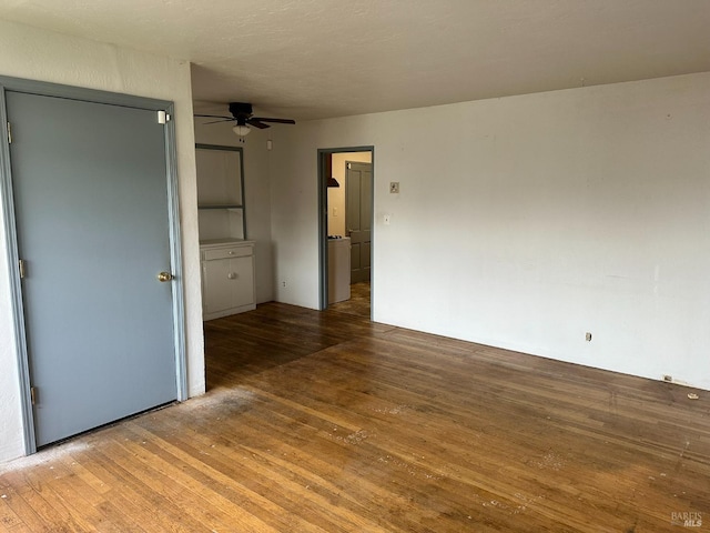 spare room with ceiling fan and wood-type flooring