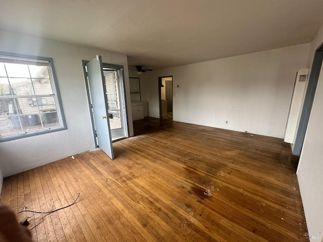 unfurnished living room featuring hardwood / wood-style floors and ceiling fan