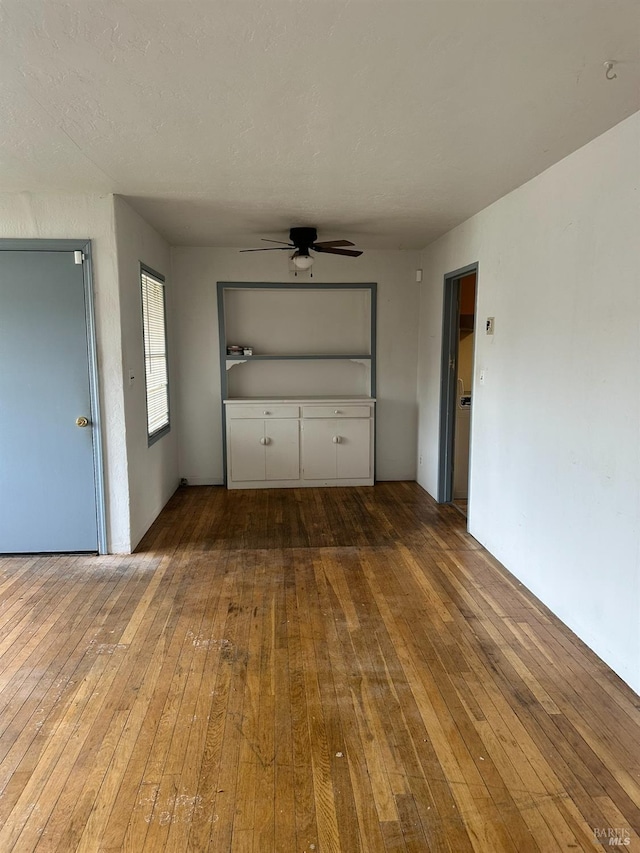 interior space with hardwood / wood-style floors and ceiling fan