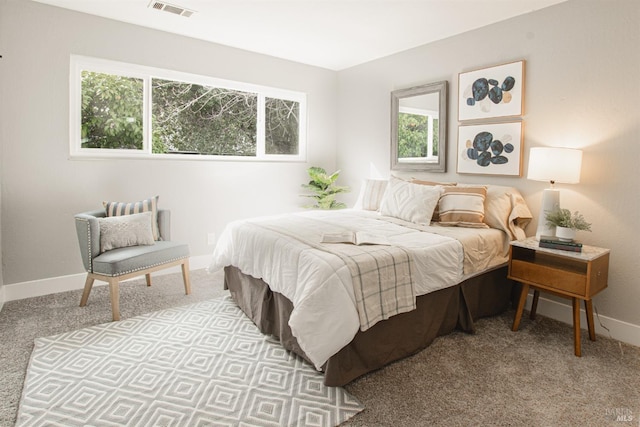 carpeted bedroom featuring visible vents and baseboards