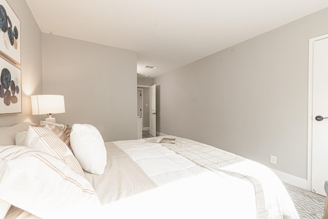 bedroom with visible vents and baseboards