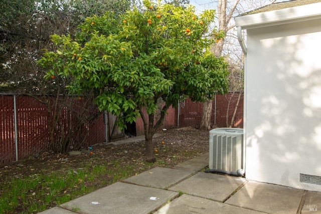 exterior space featuring central AC unit and a fenced backyard