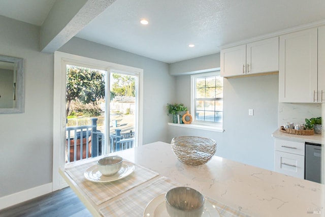 dining area with baseboards, wood finished floors, and recessed lighting