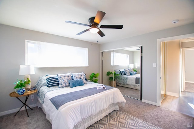 carpeted bedroom with a ceiling fan, a closet, and baseboards