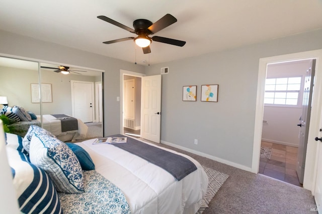 bedroom with visible vents, baseboards, ensuite bathroom, carpet, and a closet