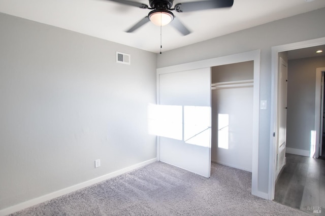 unfurnished bedroom with ceiling fan, visible vents, baseboards, a closet, and carpet