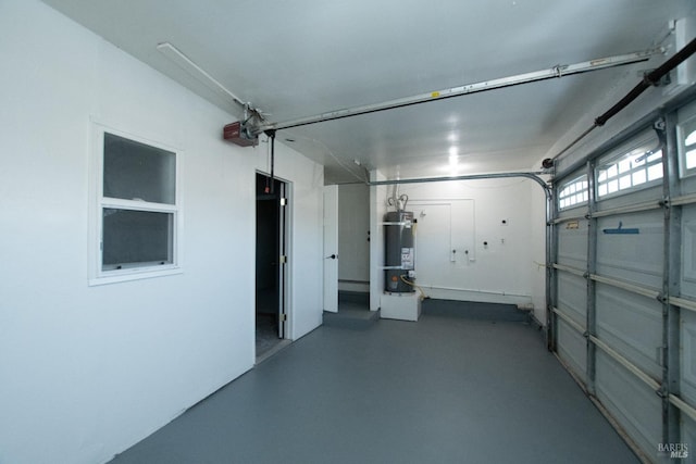 garage featuring a garage door opener and secured water heater