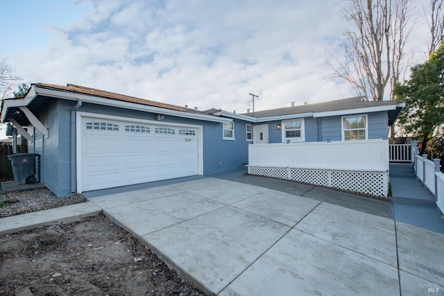 ranch-style house featuring an attached garage and driveway