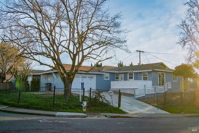 ranch-style house with a fenced front yard, a garage, and stucco siding