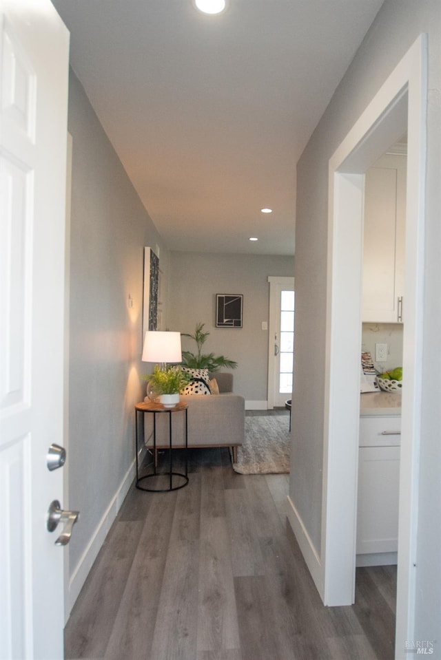 corridor with light wood finished floors, recessed lighting, and baseboards