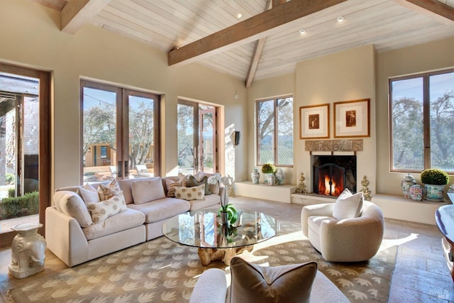 sunroom / solarium featuring plenty of natural light, wood ceiling, and a fireplace