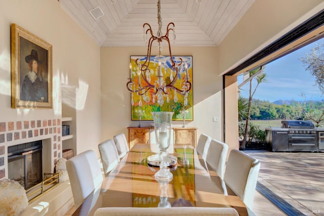 dining room featuring a fireplace, wooden ceiling, and a notable chandelier