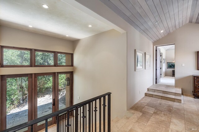 corridor featuring wooden ceiling and lofted ceiling