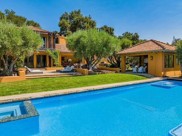 view of swimming pool featuring a lawn and a patio area