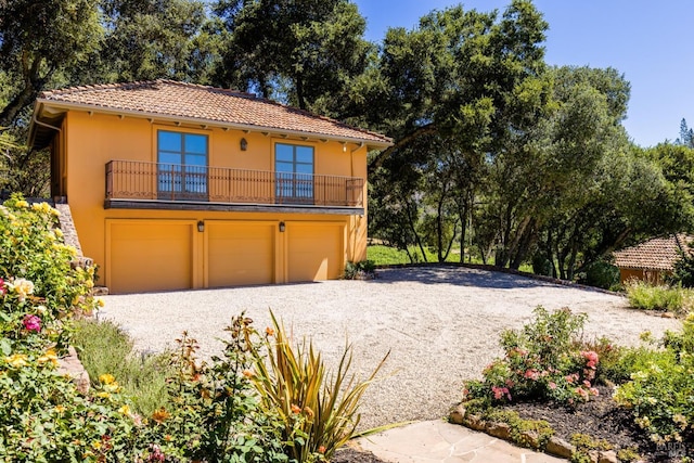 view of front of house with a balcony and a garage