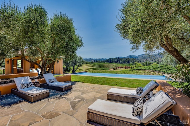 view of patio / terrace with a rural view and a swimming pool