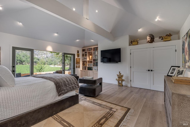 bedroom featuring light hardwood / wood-style floors and lofted ceiling