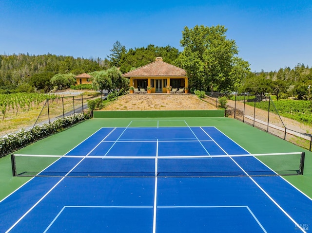 view of tennis court featuring basketball court