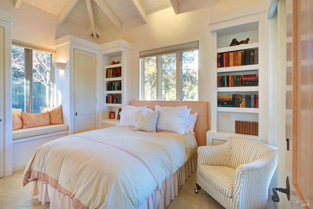 bedroom featuring lofted ceiling with beams, wood ceiling, and multiple windows