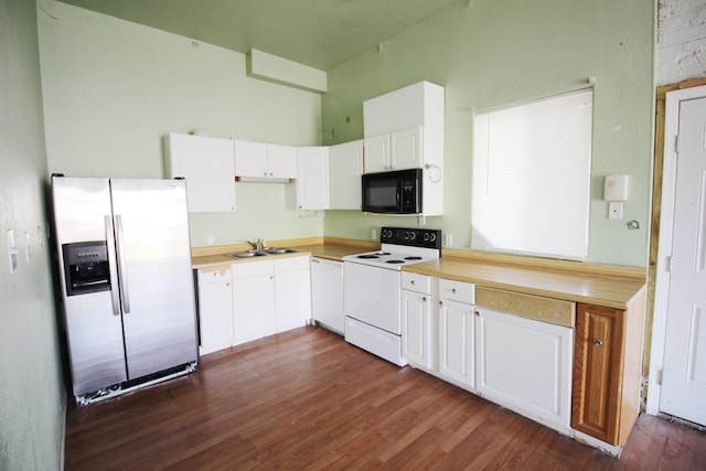 kitchen featuring white appliances, dark wood finished floors, a sink, light countertops, and white cabinets