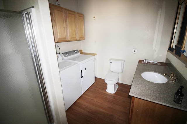 laundry room featuring baseboards, laundry area, dark wood-style floors, independent washer and dryer, and a sink