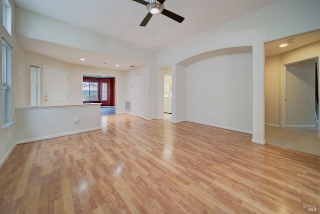 unfurnished living room with ceiling fan and light hardwood / wood-style flooring