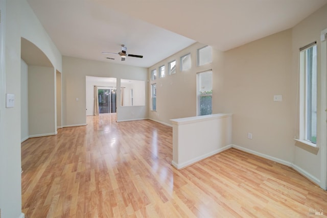 unfurnished living room with ceiling fan and light hardwood / wood-style flooring