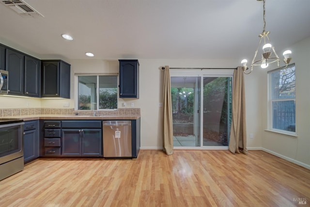 373 Shadow Creek Dr, Rio Vista, CA 94571 - kitchen featuring light wood-style flooring, visible vents, a notable chandelier, light countertops, and appliances with stainless steel finishes