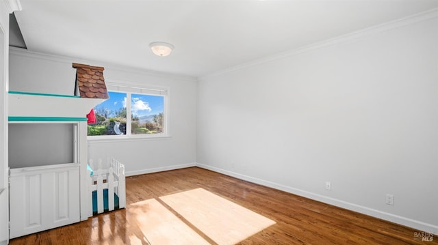 unfurnished bedroom featuring hardwood / wood-style floors and ornamental molding